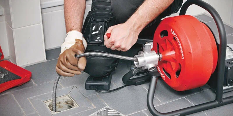 Plumber using a drain-cleaning machine in Philadelphia
