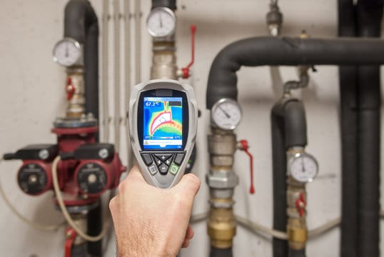 Plumber using a thermal imaging camera to inspect pipes in Philadelphia